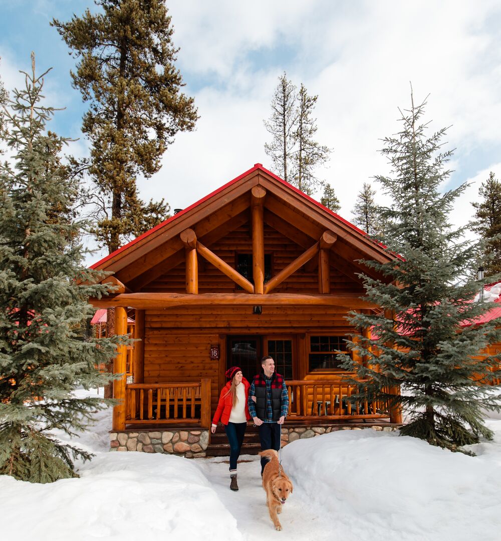 Two people walking out of a cabin at Baker Creek Resort near Lake Louise in Banff National Park